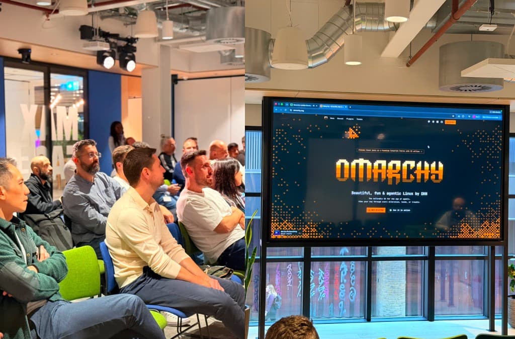 Audience at Omarchy London watching the Omarchy website on screen at Wise HQ